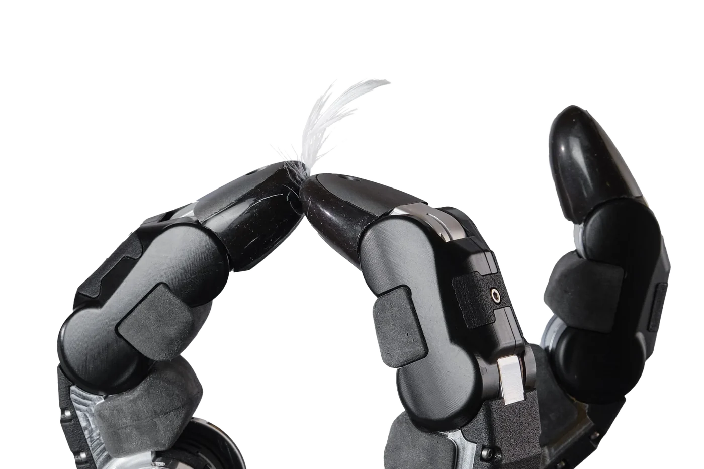 Close-up of two robotic fingertips almost touching